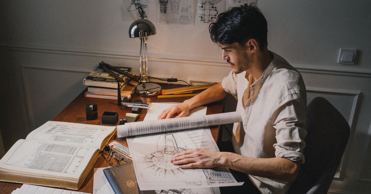 An architect reviewing blueprints with a client in a bright modern studio