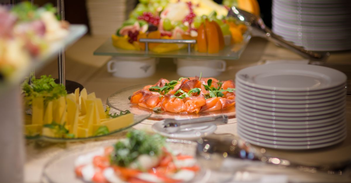 Guests enjoying a catered meal at a wedding reception