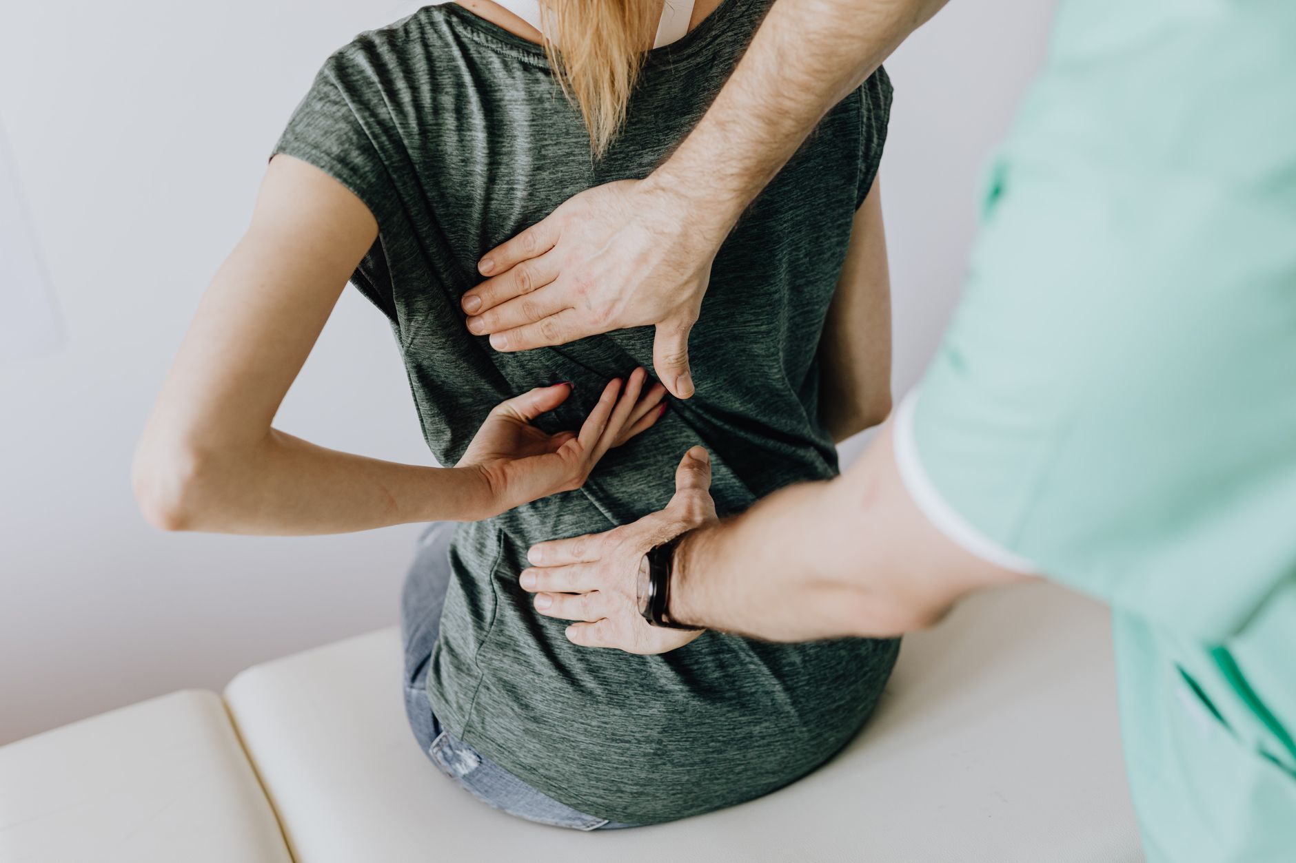 A chiropractor performing a lower back adjustment