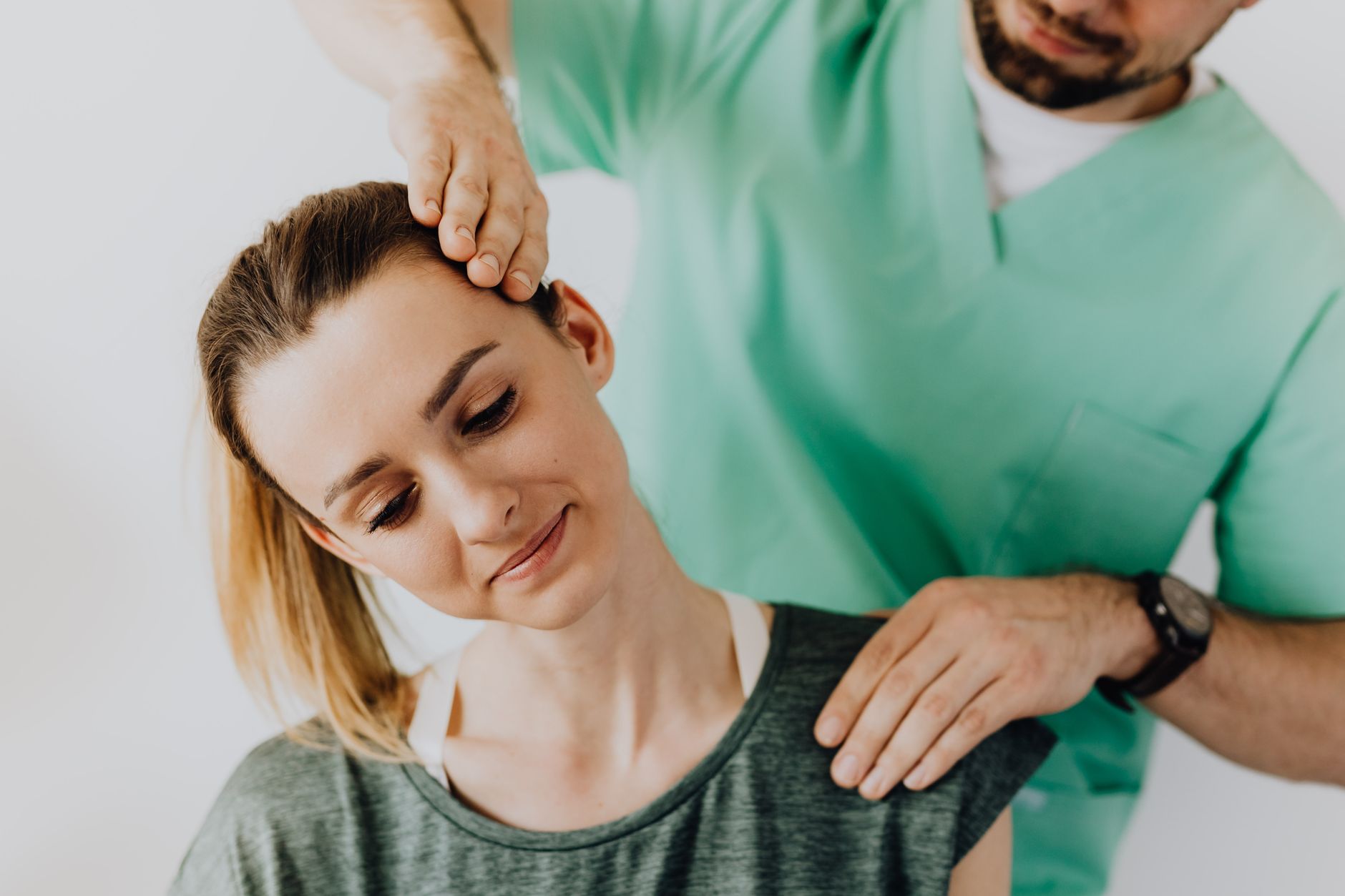 A chiropractor adjusting a relaxed patient