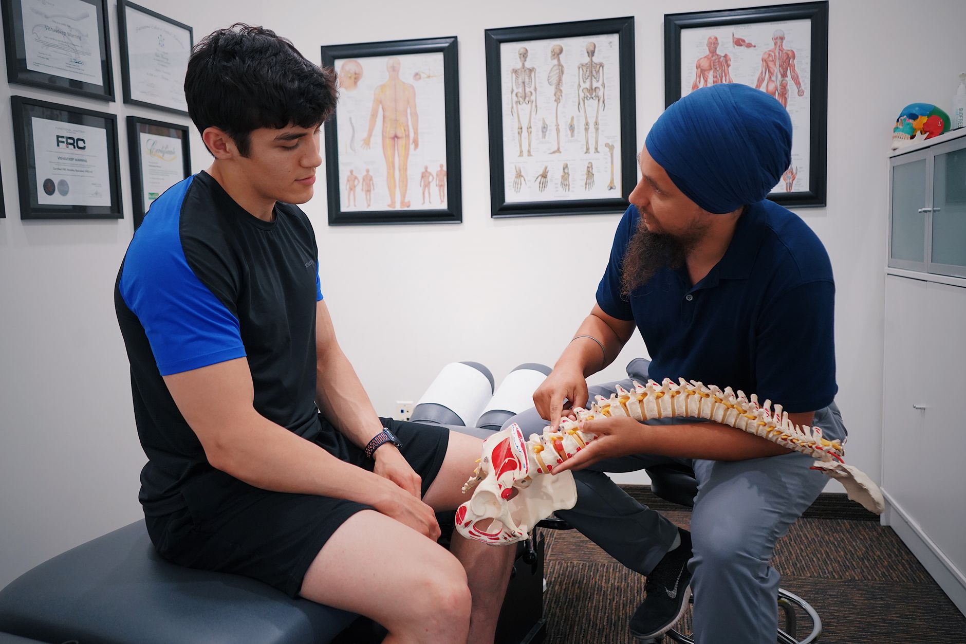 A chiropractor explaining the spine to a patient