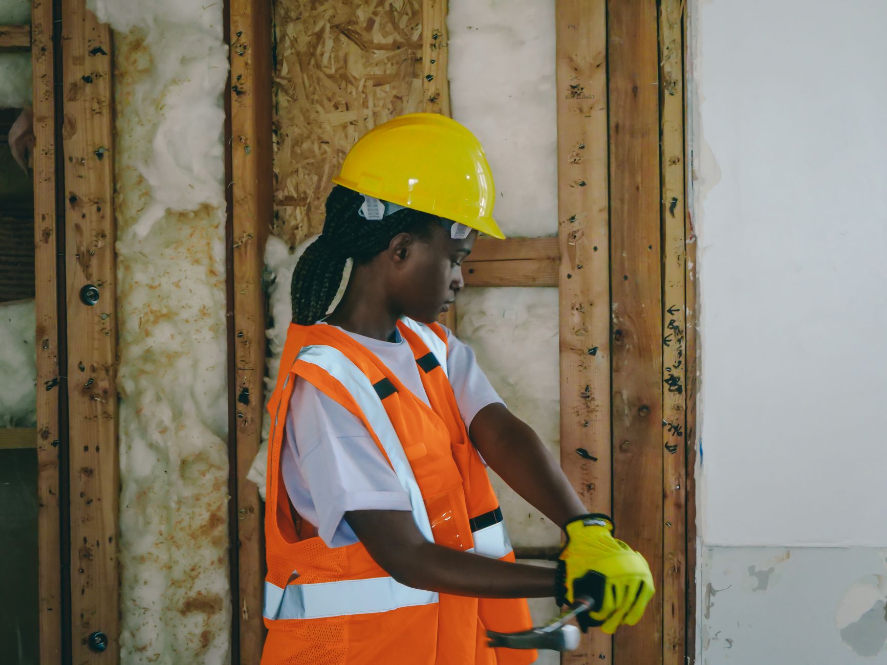 A contractor framing a home under construction