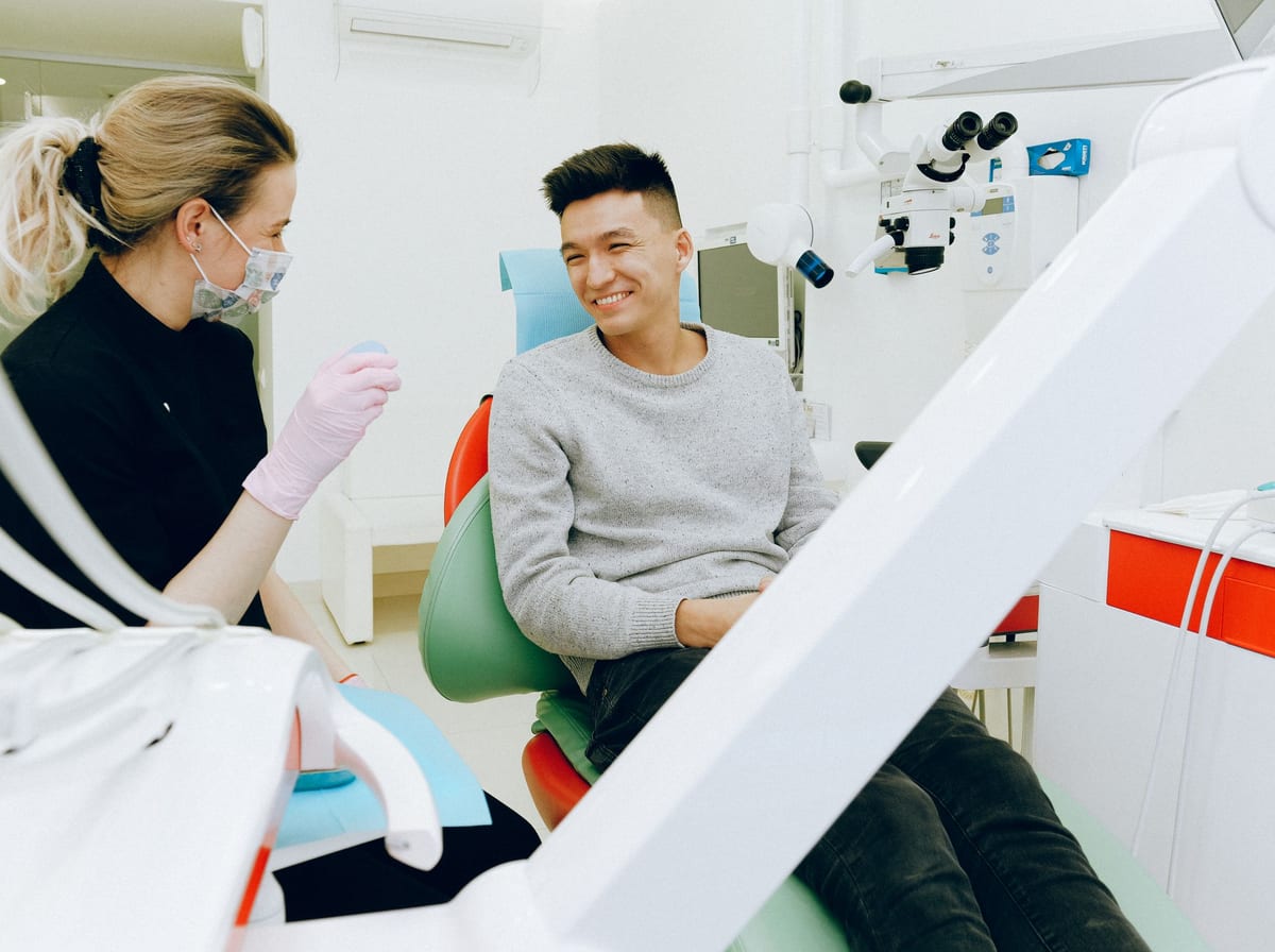 A happy patient smiling with their dentist during a friendly consultation