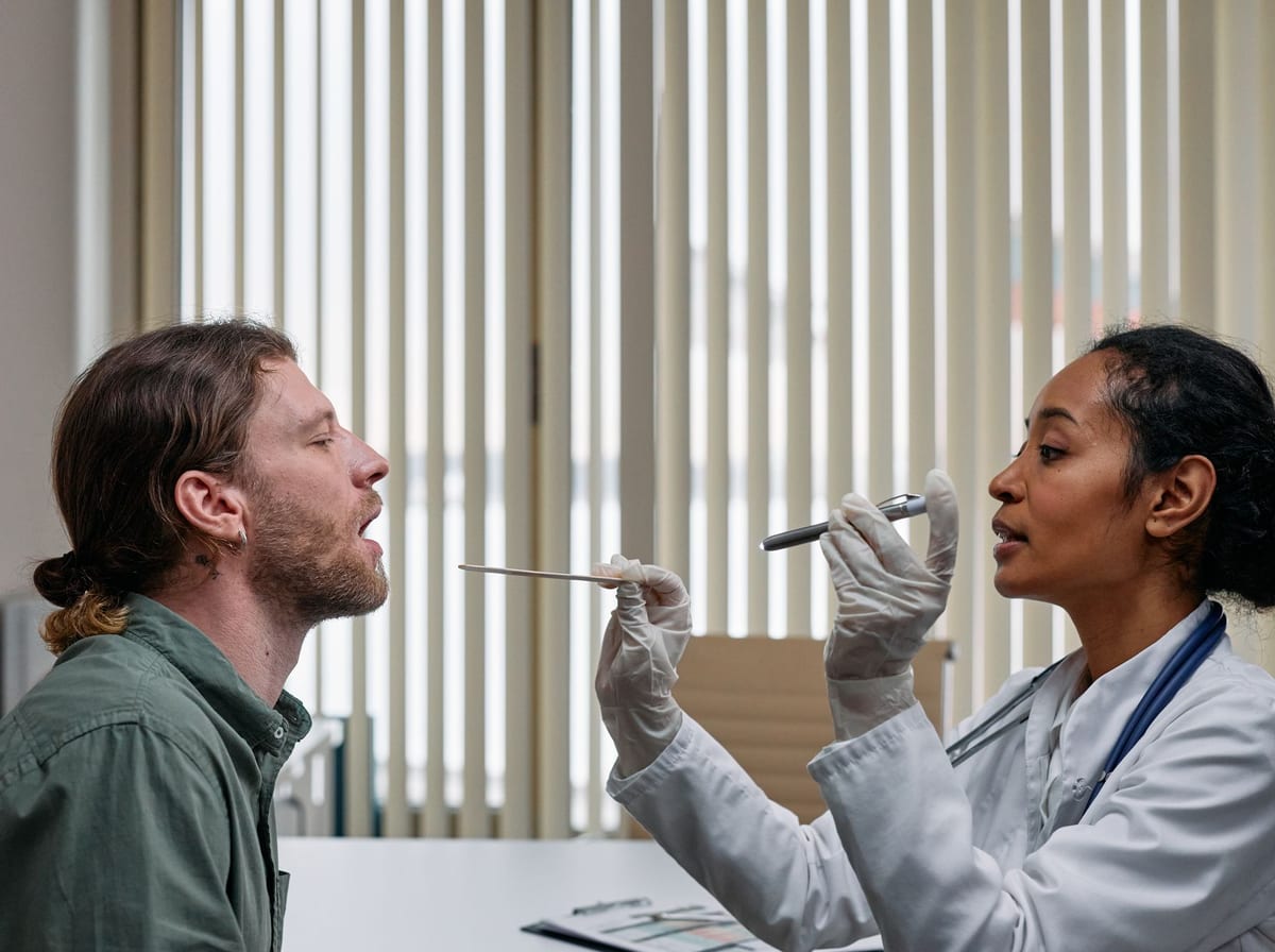 A doctor in a white coat examining a patient during a focused checkup in a bright clinic