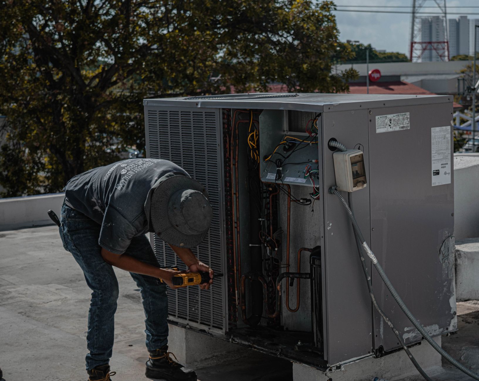 An HVAC technician repairing an air conditioning unit