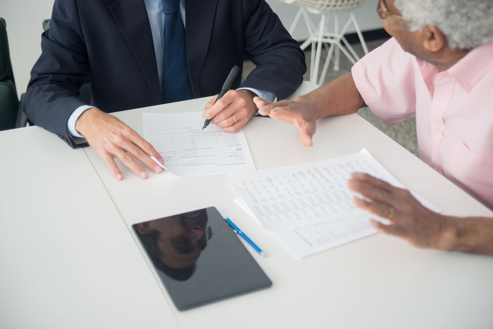 An insurance agent going over a policy with a client