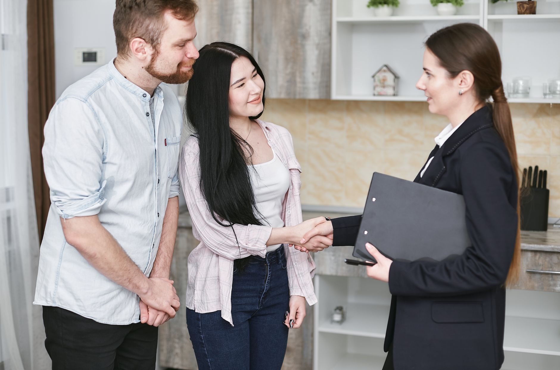 An insurance agent welcoming a new client with a handshake