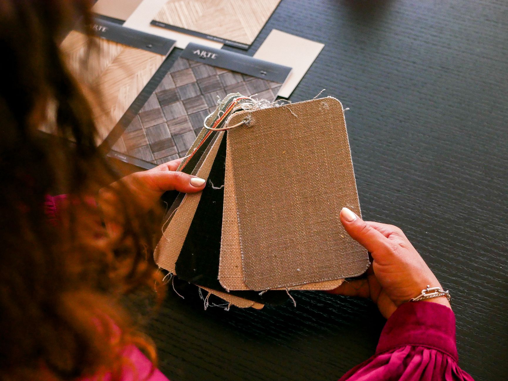 An interior designer selecting fabric and material swatches