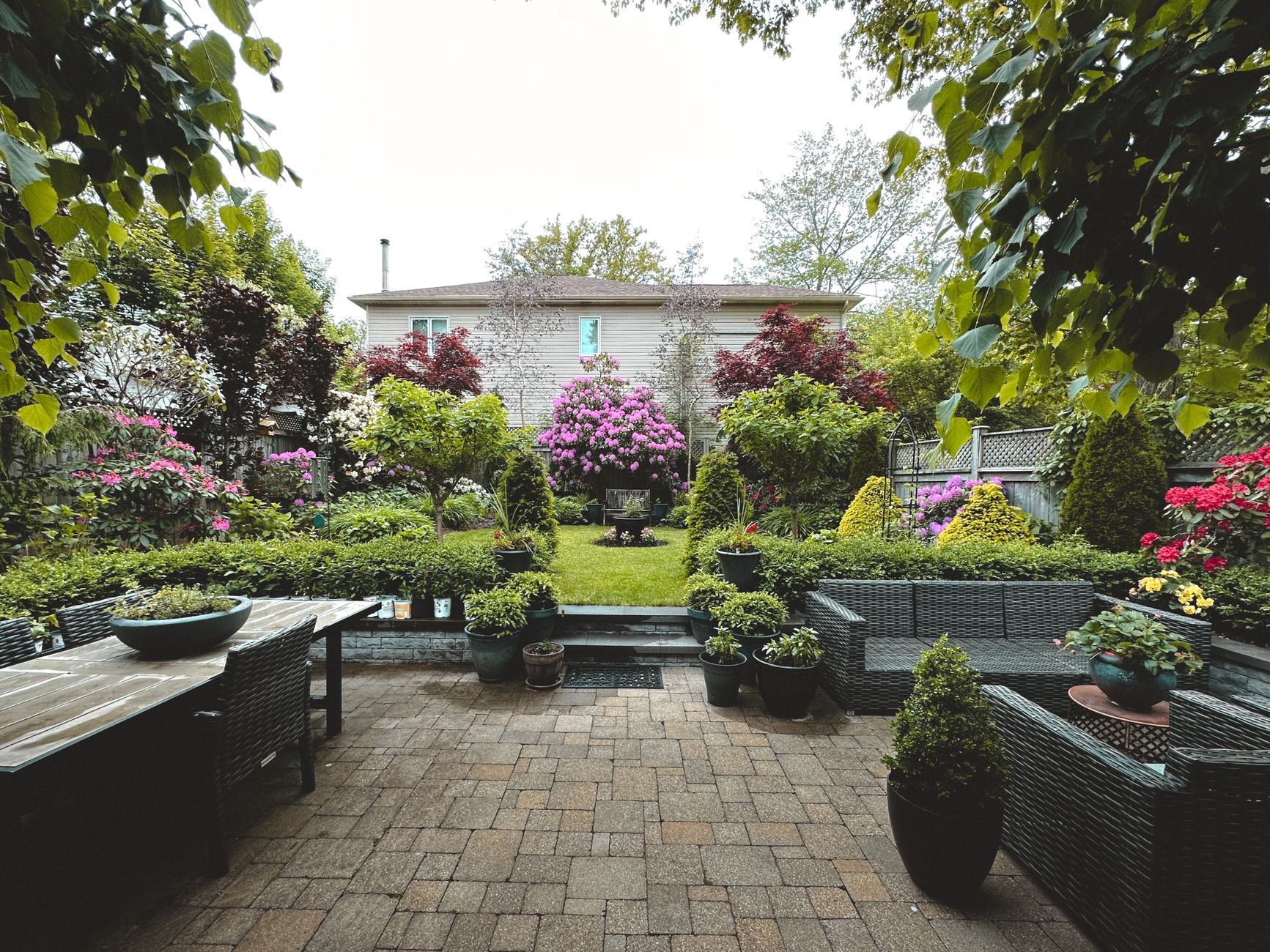 A beautifully landscaped backyard with a patio