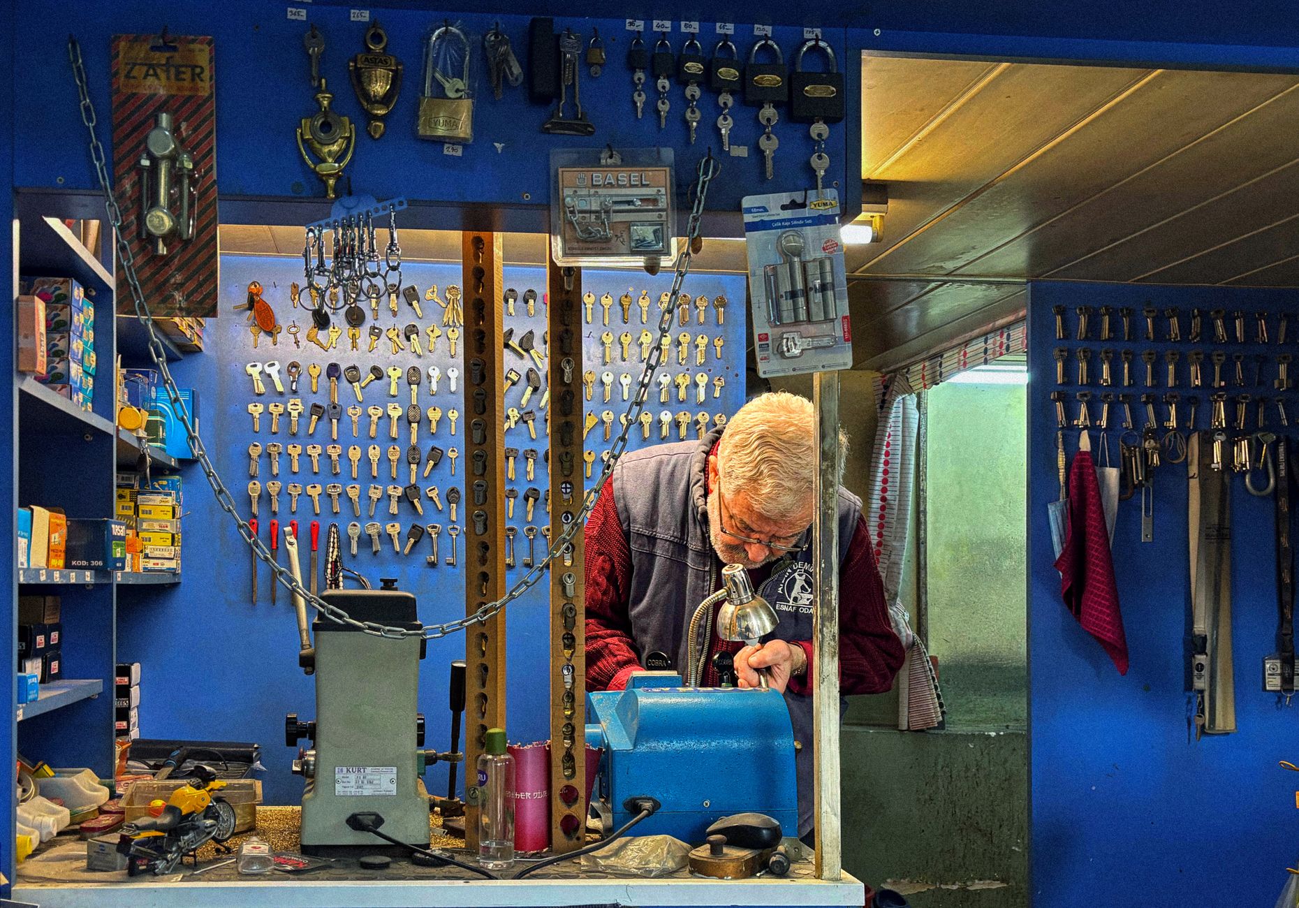 A local locksmith crafting a key in the shop