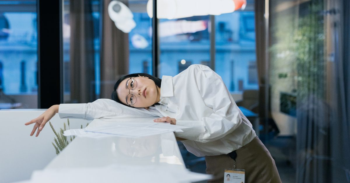A massage therapist prepping a treatment table between back-to-back appointments