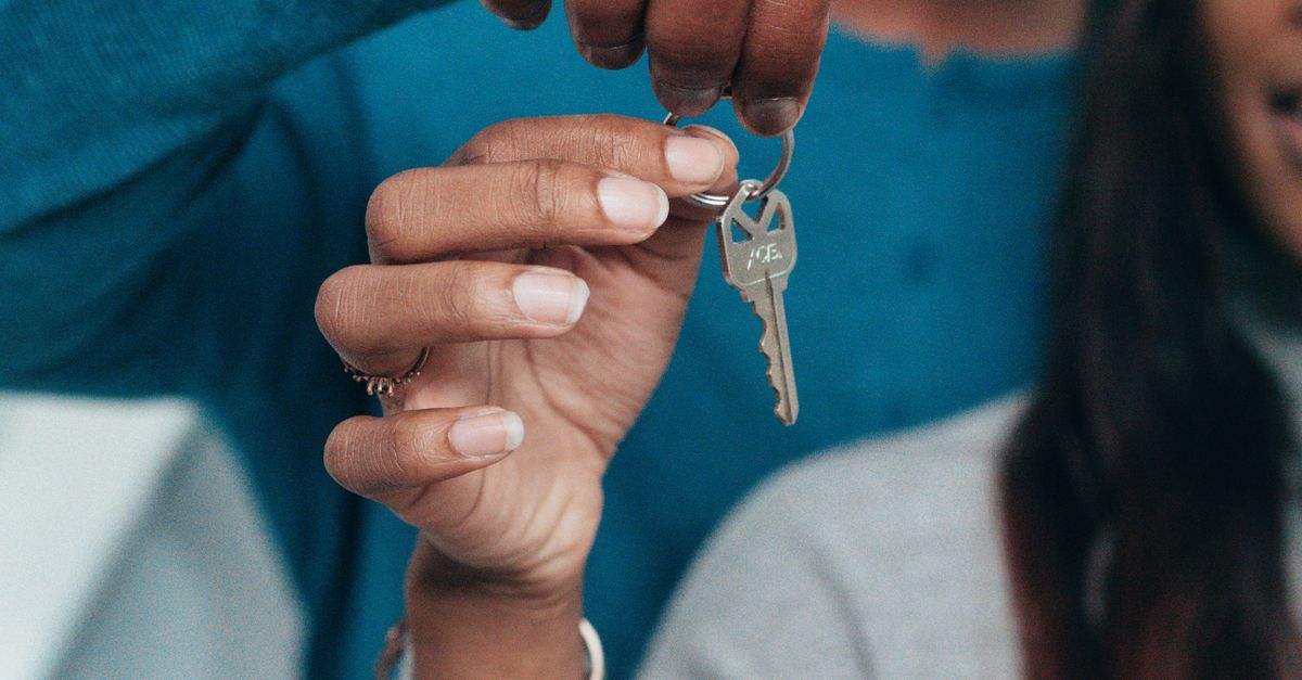 A happy couple holding house keys after closing on their new home