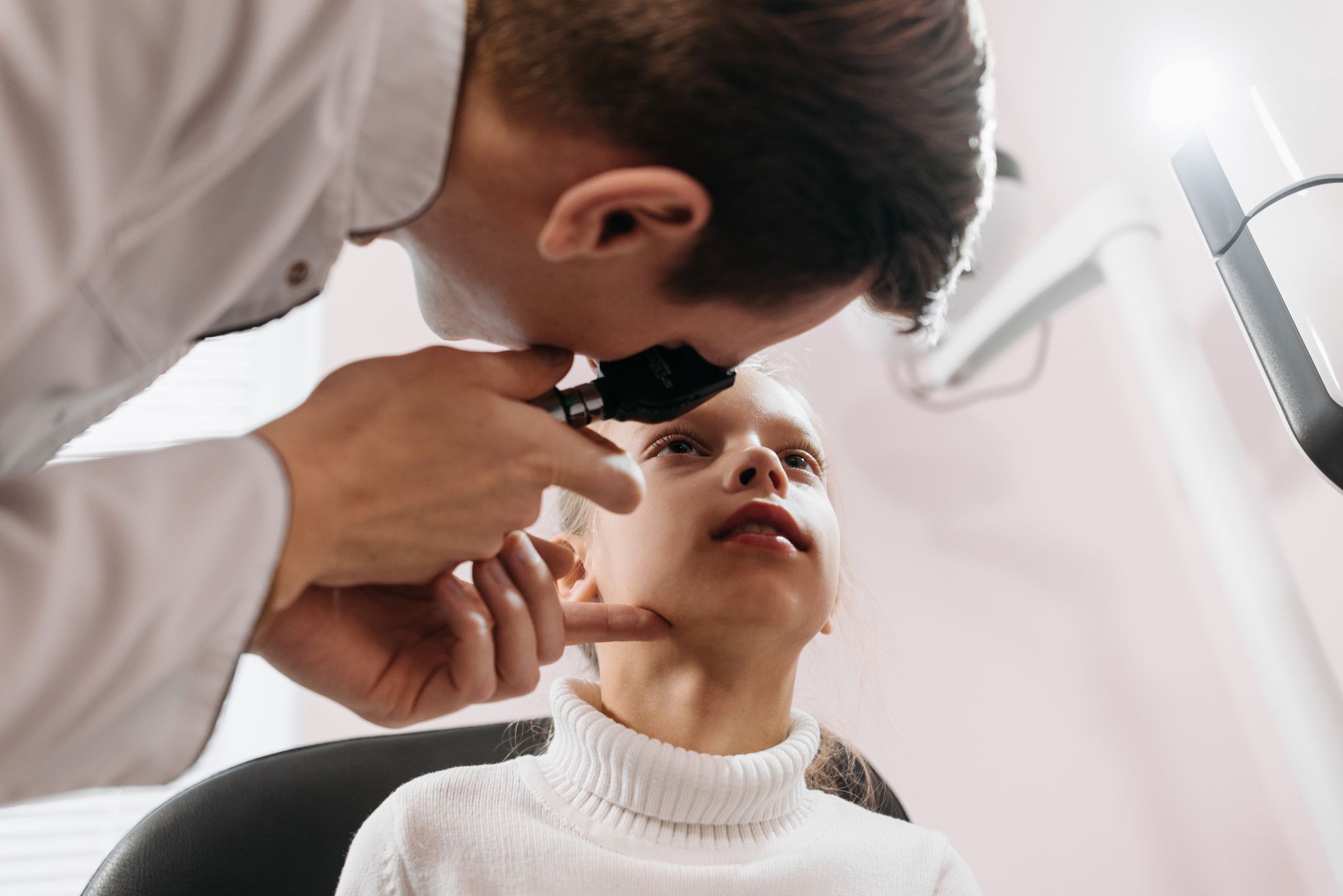 An optometrist examining a young patient's vision