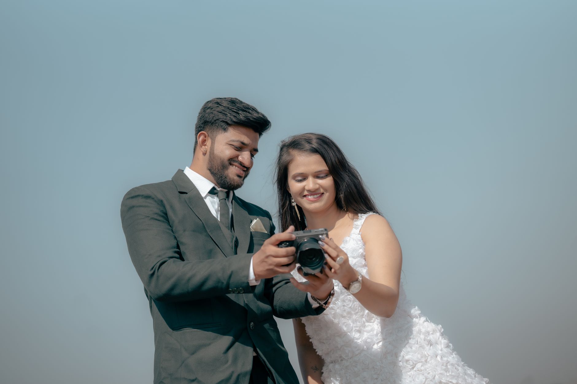A happy couple reviewing their photos with the photographer