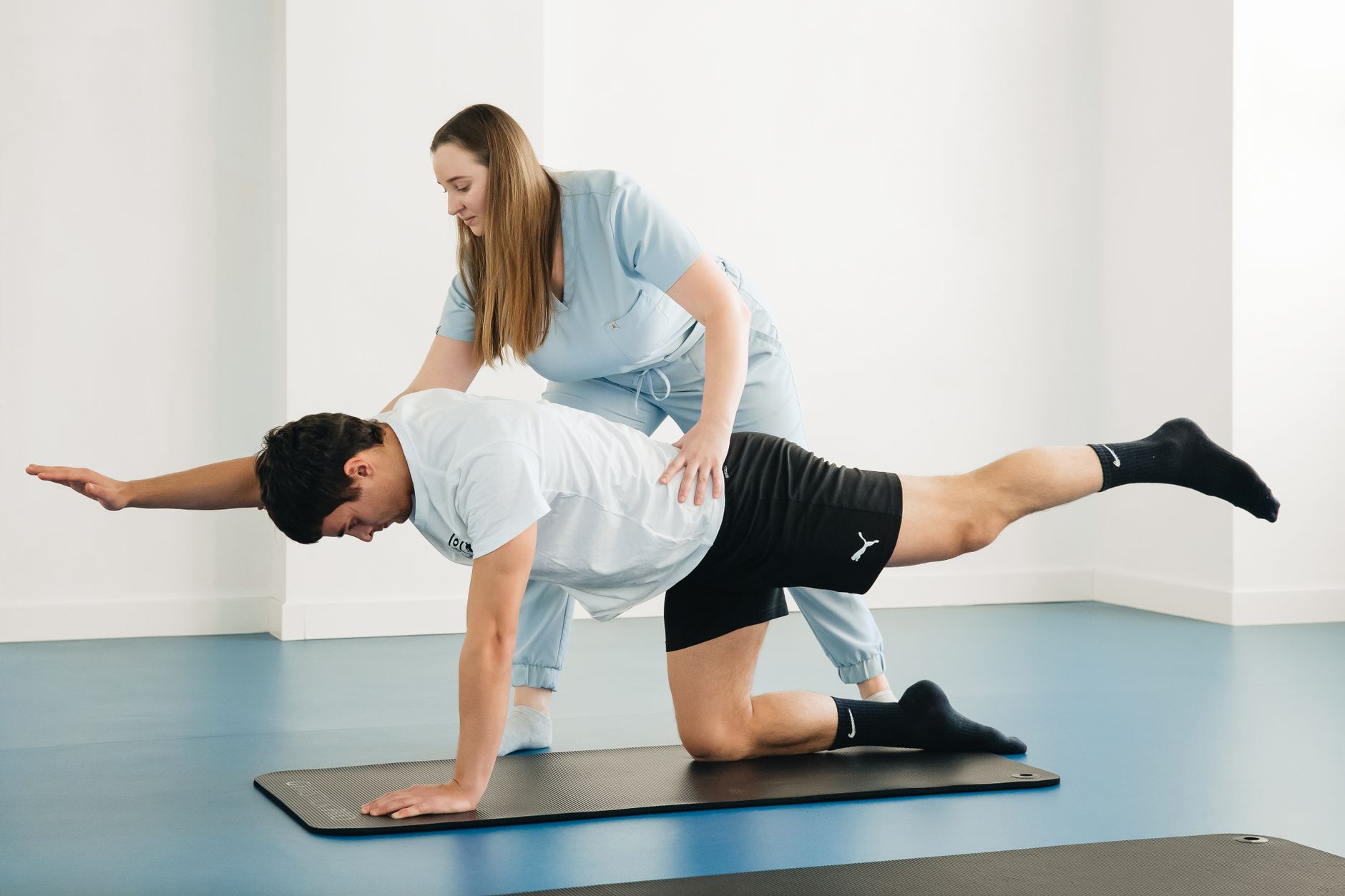 A physical therapist guiding a patient through an exercise