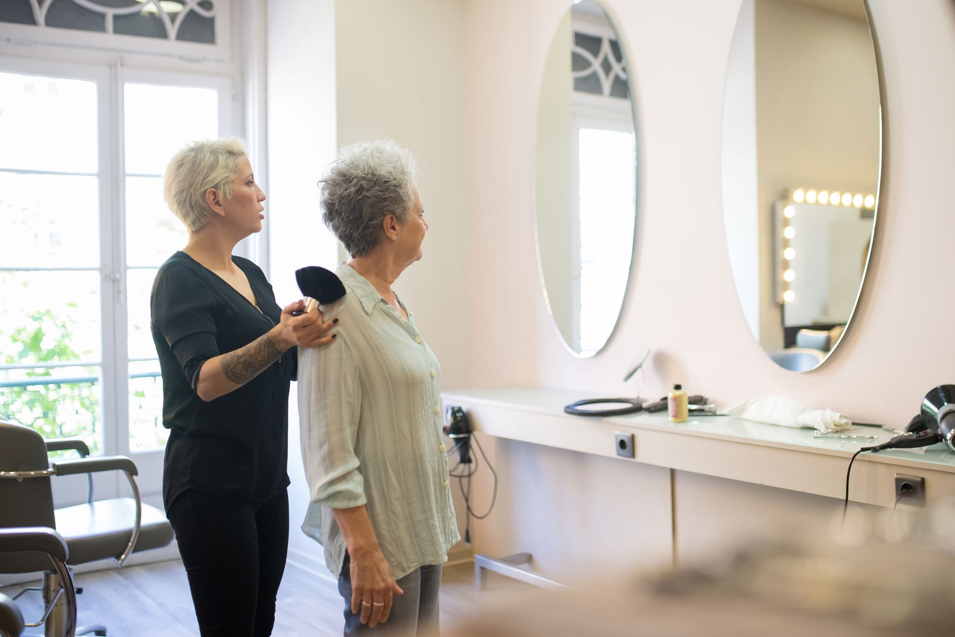 A stylist working with a client in a bright modern salon