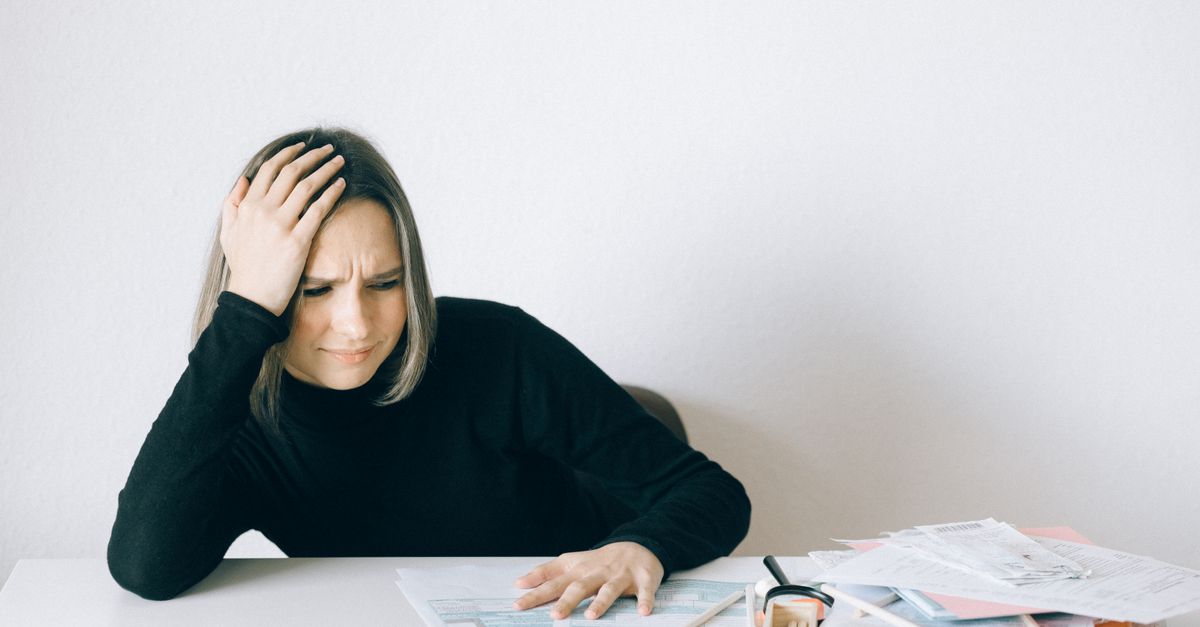 A tax preparer surrounded by return folders during filing season