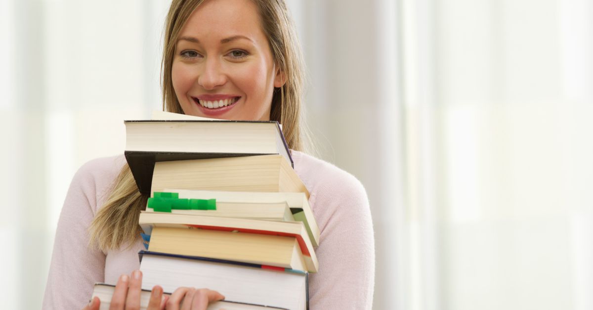 A relieved parent and their child smiling over a report card after finding the right tutor